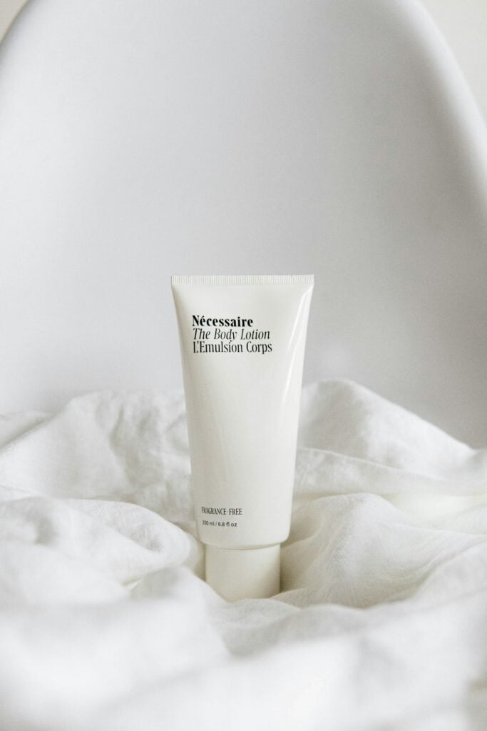 Minimalist serum dropper bottle with hydrating essence on clean stone surface