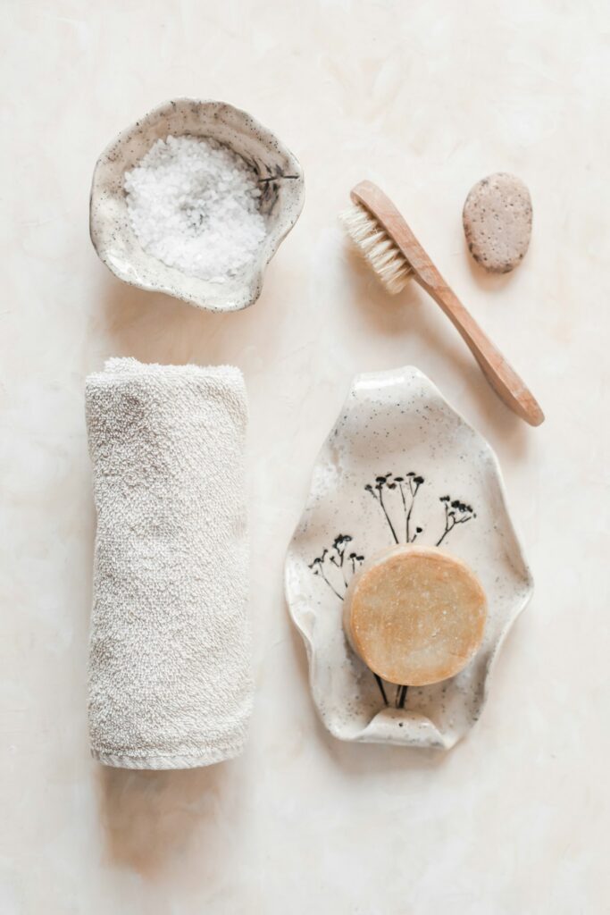 Rose quartz gua sha facial sculpting tool and calming nighttime botanical oil