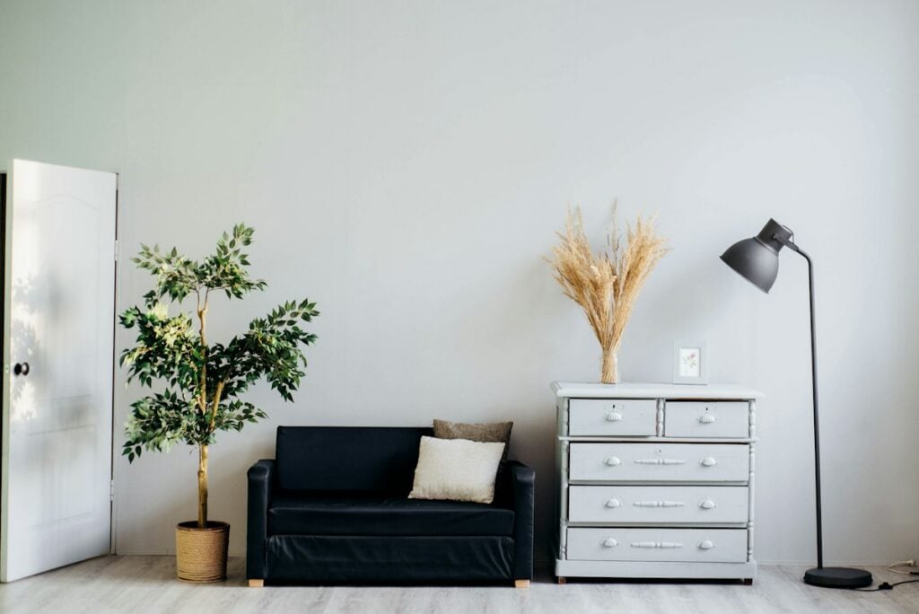 Sunlit living room with natural linen sofa and warm clay vessels
