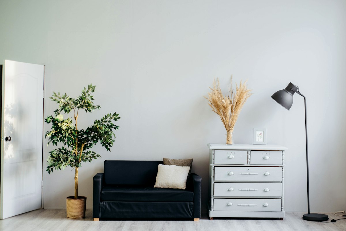 Sunlit living room with natural linen sofa and warm clay vessels