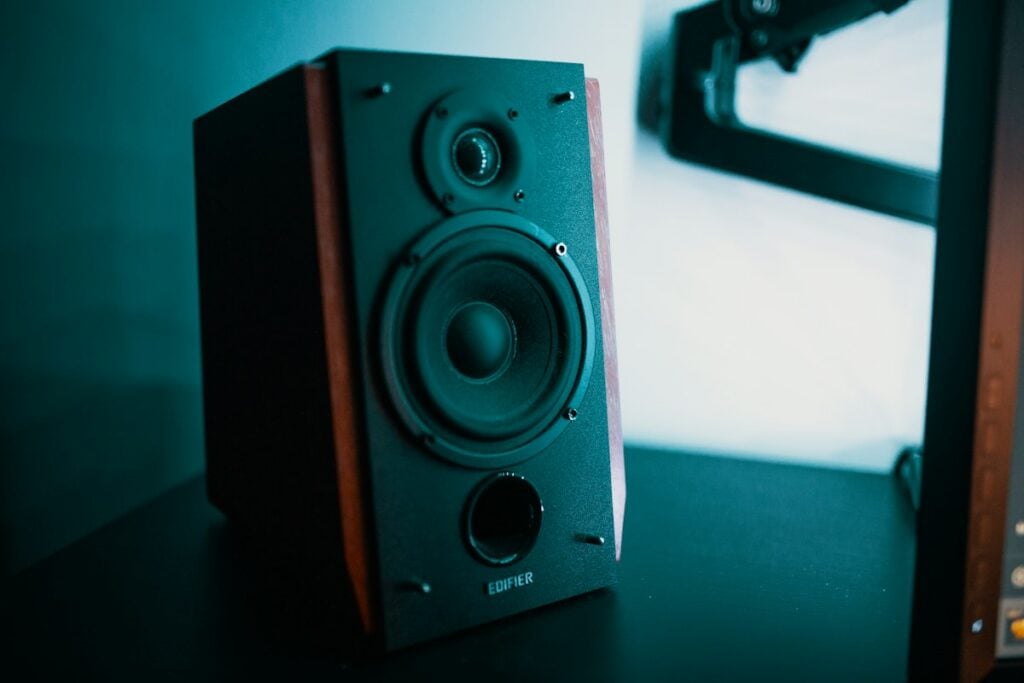 Warm wood-grain vintage audio speaker with brass details