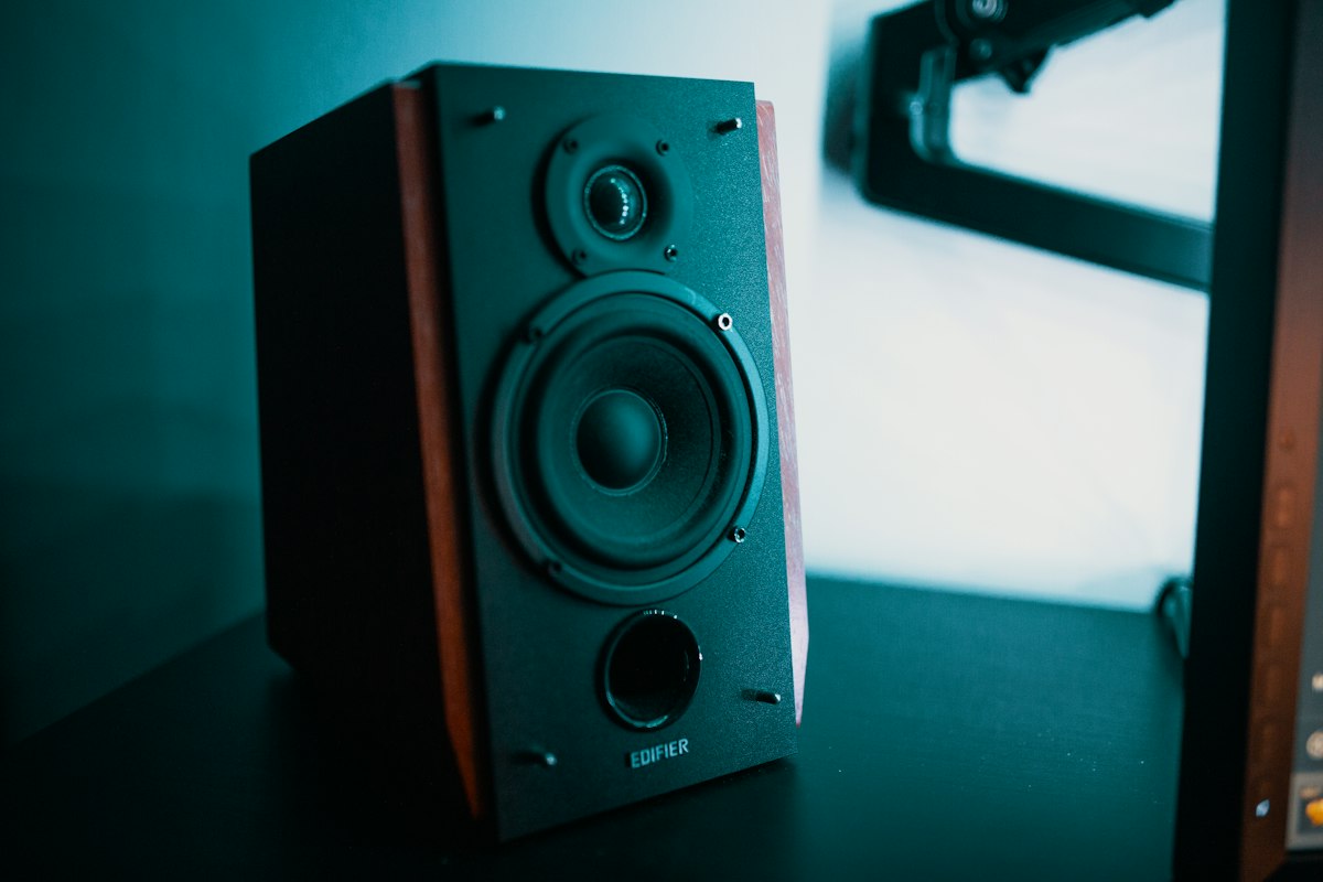 Warm wood-grain vintage audio speaker with brass details