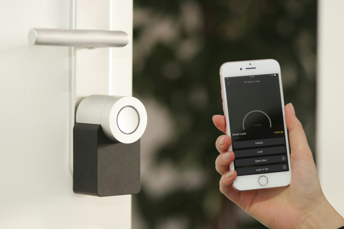 Clean Scandinavian interior with concealed smart thermostat and blinds